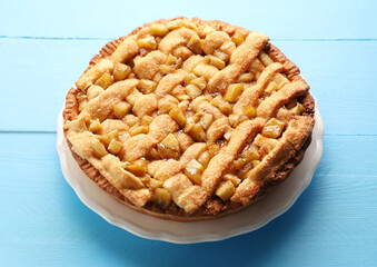 Tasty homemade apple pie on light blue wooden table