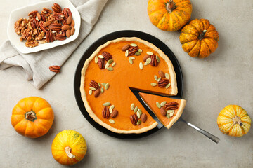 Tasty homemade pumpkin pie served on grey table, top view