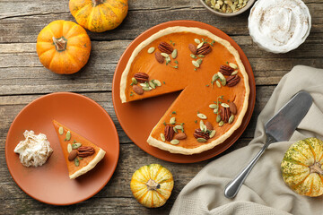 Tasty homemade pumpkin pie served on wooden table, top view