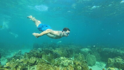 under water young man snorkeling on tailand