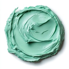 Closeup of a swirl of light green cosmetic cream on a white background.