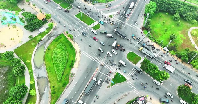 Aerial view of Saigon cityscape at morning with a complex highway intersection in Southern Vietnam. Urban development texture, transport infrastructure and green parks