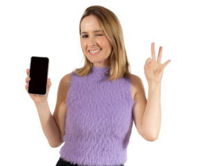 Portrait of a smiling young woman showing blank screen mobile phone with okay sign isolated over transparent background. PNG transparent.