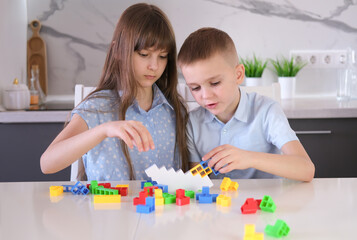 Fototapeta premium Children playing balancing board game. Family spending time together at home enjoying intellectual logic games.