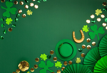 St. Patrick's Day leprechaun Hat, Gold Coins, Shamrocks and Party Favors on Green Background.