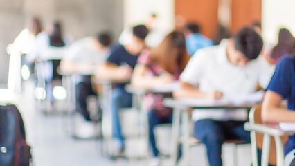Exam Anxiety in Blurred Hall: Blurred background of a test hall with students taking exams.
