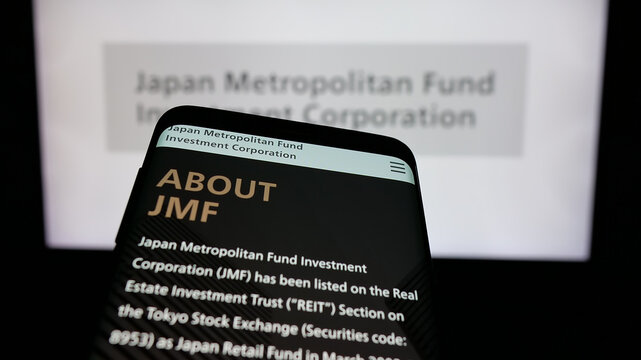 Stuttgart, Germany - 01-14-2025: Mobile phone with website of Japan Metropolitan Fund Investment Corporation (JMF) on screen in front of logo. Focus on top-left of phone display.