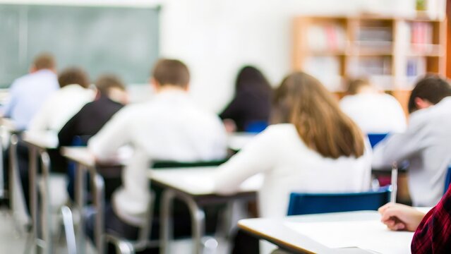 Classroom with Test Papers: Blurred image of students taking tests in a classroom.
