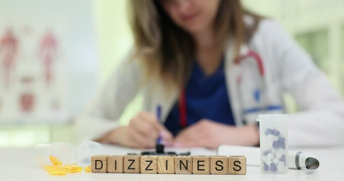 A healthcare worker notes the patients dizziness symptoms with colorful scrabble tiles, showing medical analysis