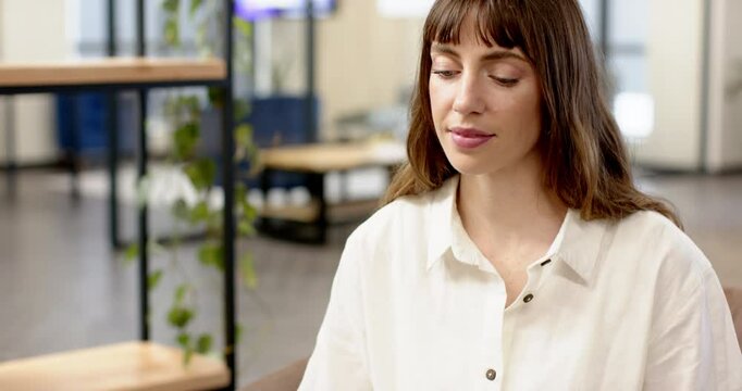Smiling woman in office, focusing on creative writing business project