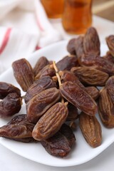 Tasty dried dates on white table, closeup