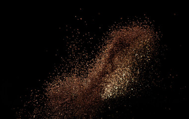 Roasted Coffee powder ground dust splash explosion in mid Air. Ground Coffee roasted powder dust fly explosion, Coffee crushed ground float pouring. Black background Isolated
