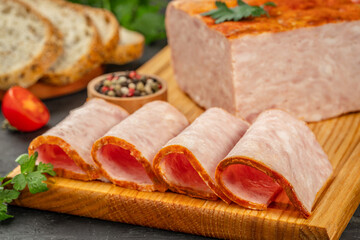 Delicious ham. artisanal whole smoked slab bacon on a cutting block on a wooden board, top view