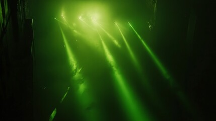 Obraz premium Upward angled photography capturing mesmerizing display of emerald laser lights forming geometric matrices and tunnels through fog-filled venue space, strong contrast between pure darkness and
