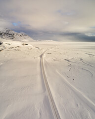 Aerial view of Road Number One cutting through a snowy landscape in South Iceland