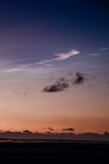 Polar stratospheric clouds glowing at twilight over South Iceland's horizon