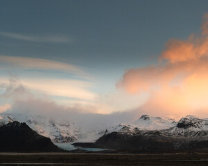 Vivid sunrise over snow-covered mountains in Öræfi, South Iceland.
