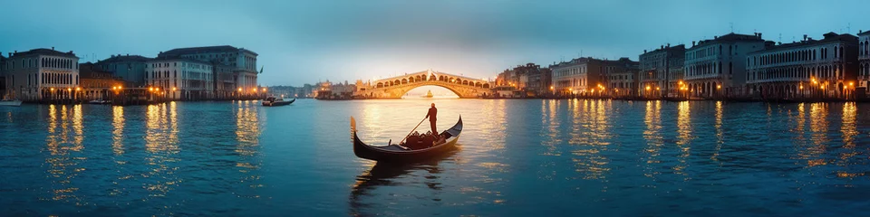 Scenic night view of Rialto Bridge and gondola on Venice's Grand Canal