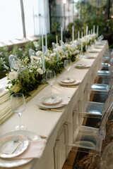 Modern stylish wedding table setting. The wedding decor. The pastel colors flowers bouquet. Natural beautiful wedding decorations. Minimalistic wedding decorations