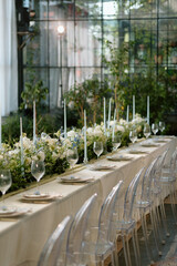 Modern stylish wedding table setting. The wedding decor. The pastel colors flowers bouquet. Natural beautiful wedding decorations. Minimalistic wedding decorations