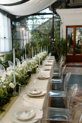 Modern stylish wedding table setting. The wedding decor. The pastel colors flowers bouquet. Natural beautiful wedding decorations. Minimalistic wedding decorations