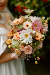 Modern stylish wedding bouquet of wild flowers. The wedding decor. The pastel colors flowers bouquet. Natural beautiful wedding decorations. Minimalistic wedding decorations