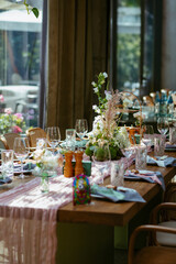 Modern stylish wedding table setting. Fairytale wedding decoration. Vibrant colors, vintage style. The pastel colors flowers bouquet. Natural beautiful wedding table setting  