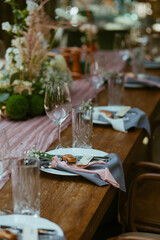 Modern stylish wedding table setting. Fairytale wedding decoration. Vibrant colors, vintage style. The pastel colors flowers bouquet. Natural beautiful wedding table setting  
