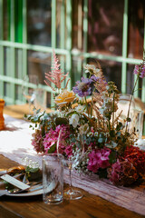 Modern stylish wedding table setting. Fairytale wedding decoration. Vibrant colors, vintage style. The pastel colors flowers bouquet. Natural beautiful wedding table setting  