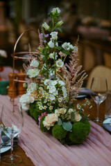 Modern stylish wedding table setting. Fairytale wedding decoration. Vibrant colors, vintage style. The pastel colors flowers bouquet. Natural beautiful wedding table setting  