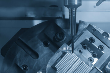 The 5-axis CNC milling machine  cutting the automotive part with solid ball end mill tool.