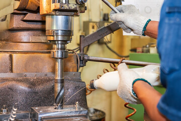 The hole drilling  process on NC milling machine with manual feeding liquid coolant method.