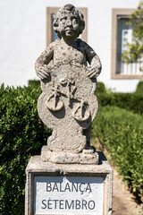 Obraz premium Stone statue depicting the balance sign belonging to the episcopal garden of the city of Castelo Branco-Portugal.