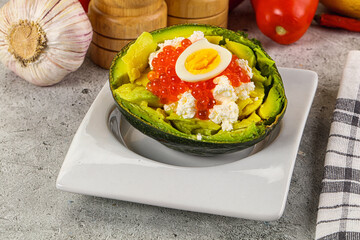 Avocado with red caviar and quil egg
