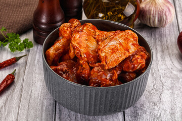 Raw marinated buffalo chicken wings
