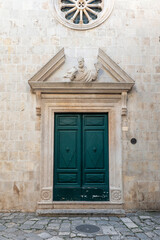 An old decorated vintage door in the old town of Trogir, Croatia