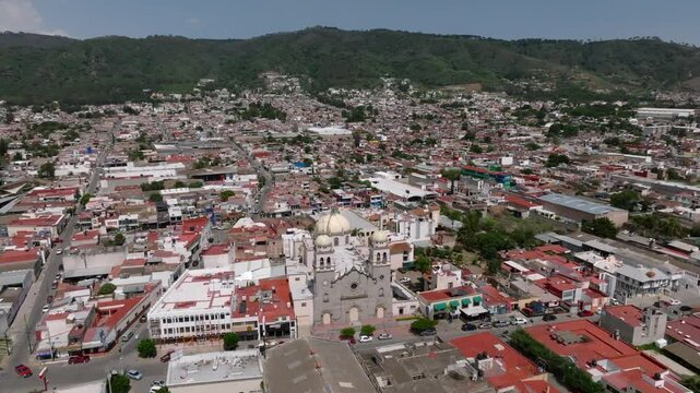 Ciudad Guzman San Pedro Church and surrounding town in aerial orbital shot from front entrance