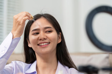 Beauty broker applying skincare serum during a live broadcast demonstration