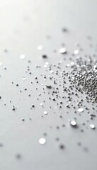 Luxurious silver glitter scattered on white, shimmering surface, bright, elegant