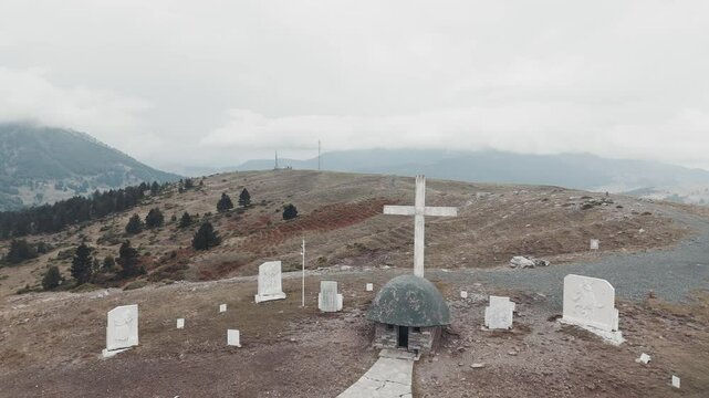 The Annitsa Monument in Greece, a helmet shaped church and a huge cross, honors the resistance fighters of WWII, drone shot.
