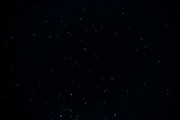 The clear black night sky is strewn with stars