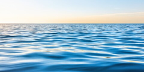 Obraz premium Calm and endless ocean view with gentle ripples under a golden sky capturing tranquility simplicity and the serenity of nature’s expanse