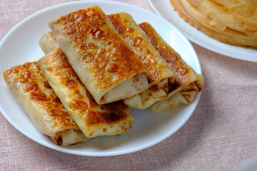Thin pancakes with cottage cheese, rolled into a tube. A festive dish for the pagan Slavic holiday Maslenitsa