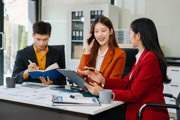 Business team working on a project in the office or reviewing and discussing a business project.