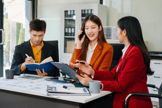 Business team working on a project in the office or reviewing and discussing a business project.
