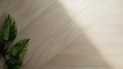 A leaf is placed on a wooden floor, creating a contrast between the natural