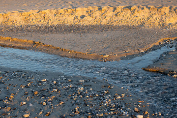 Detail of a beach with small river, Spadafora, Sicily, Italy