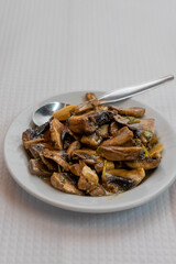 Sauteed mushrooms served as appetizers on a table in a traditional Portuguese restaurant, showcasing authentic local cuisine.