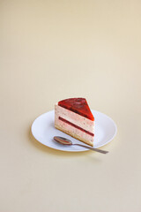 Raspberry Mousse Cake Slice on White Plate with Minimalist Background