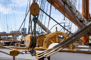 Ship rigging and wheel in nautical setting